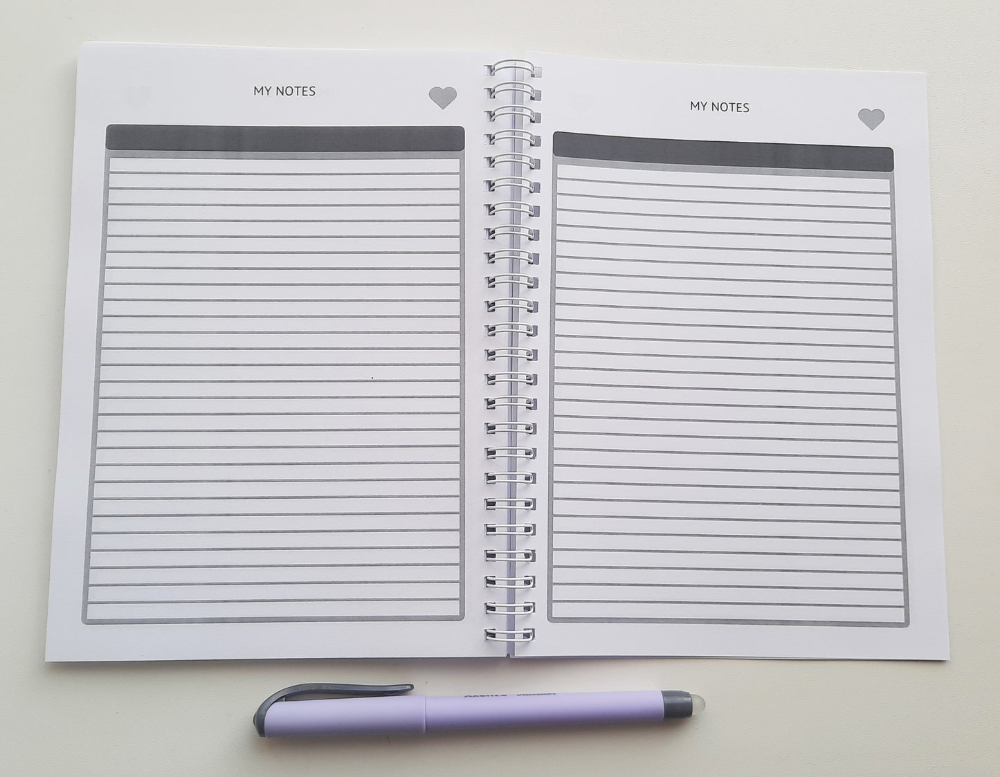 a notepad with a pen on top of it