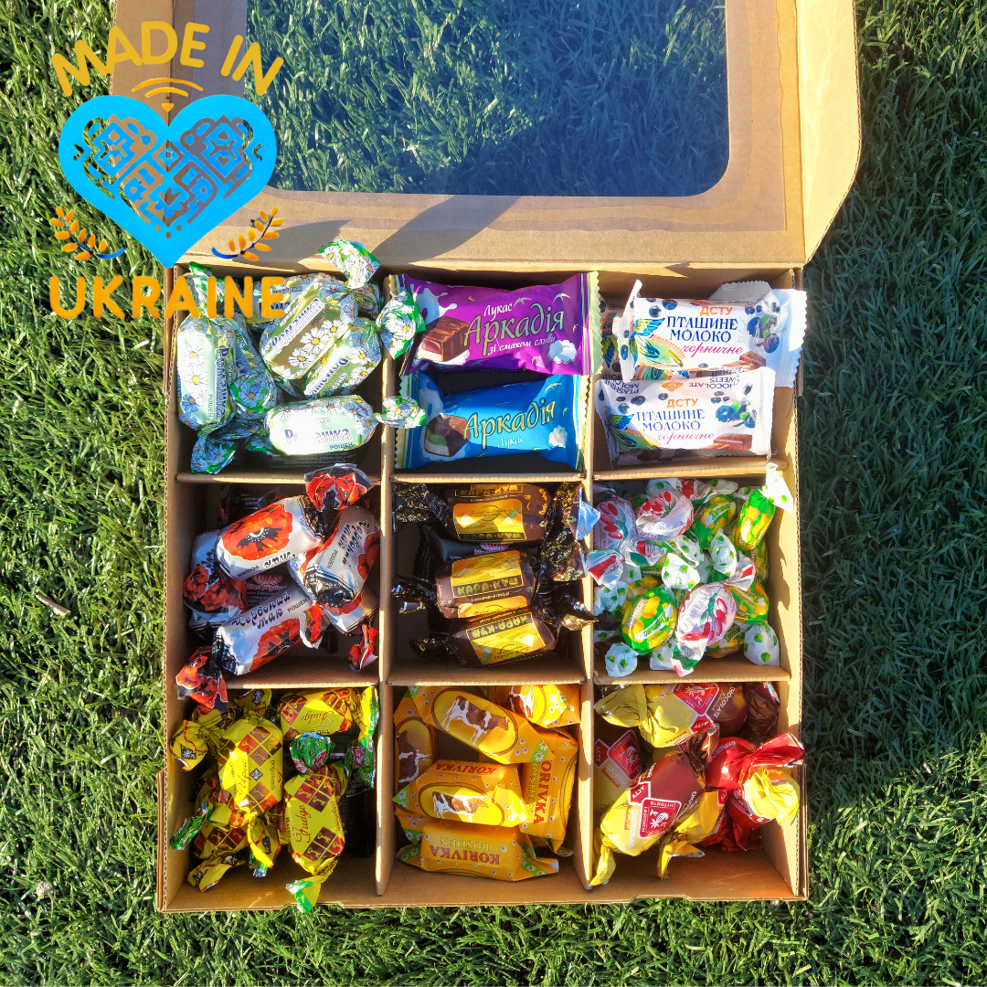 a box filled with candy sitting on top of a green field