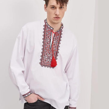 a man wearing a white shirt with a red tassel