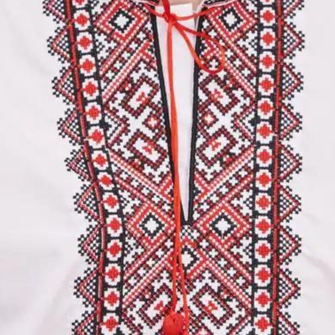 a white shirt with a red and black design on it