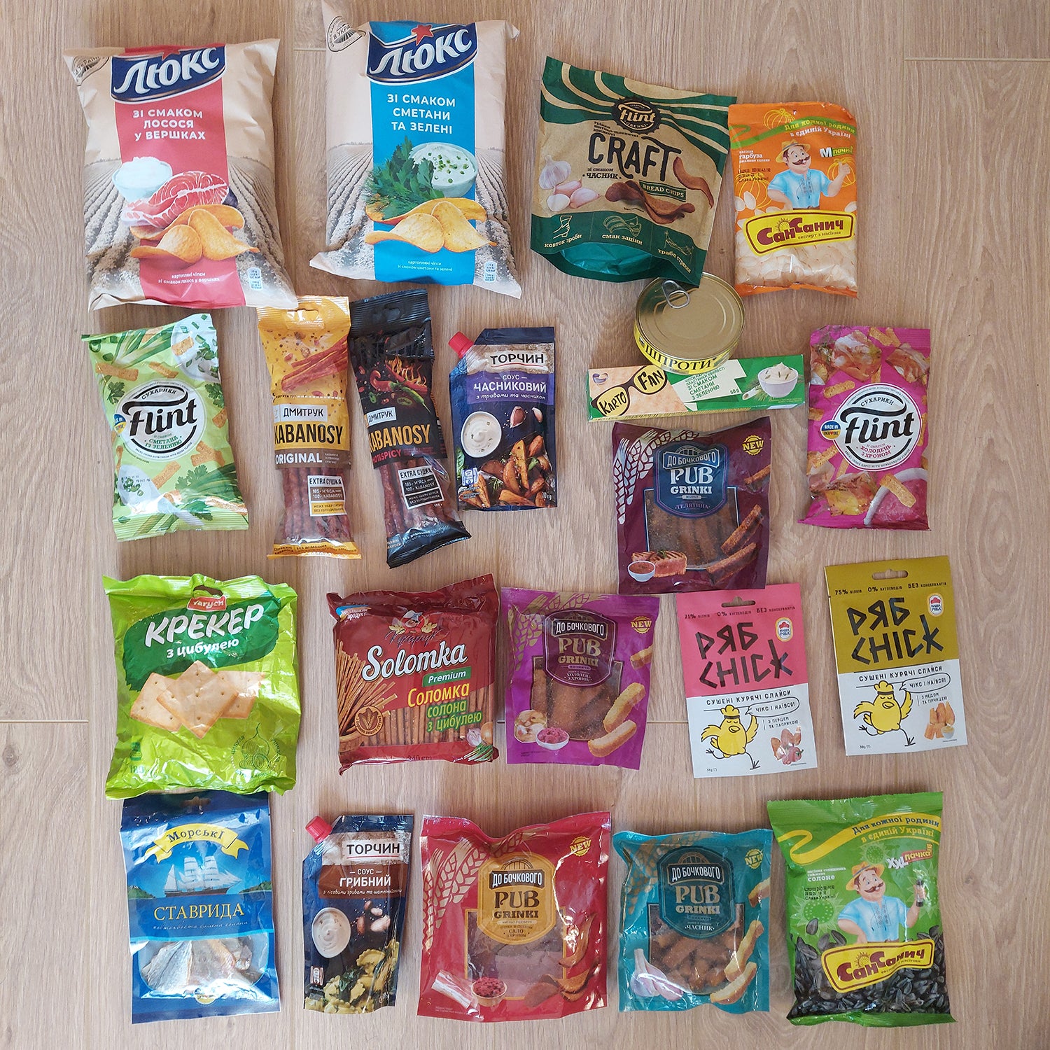 a variety of snacks laid out on a wooden floor