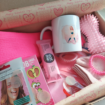 the contents of a pink box are neatly packed