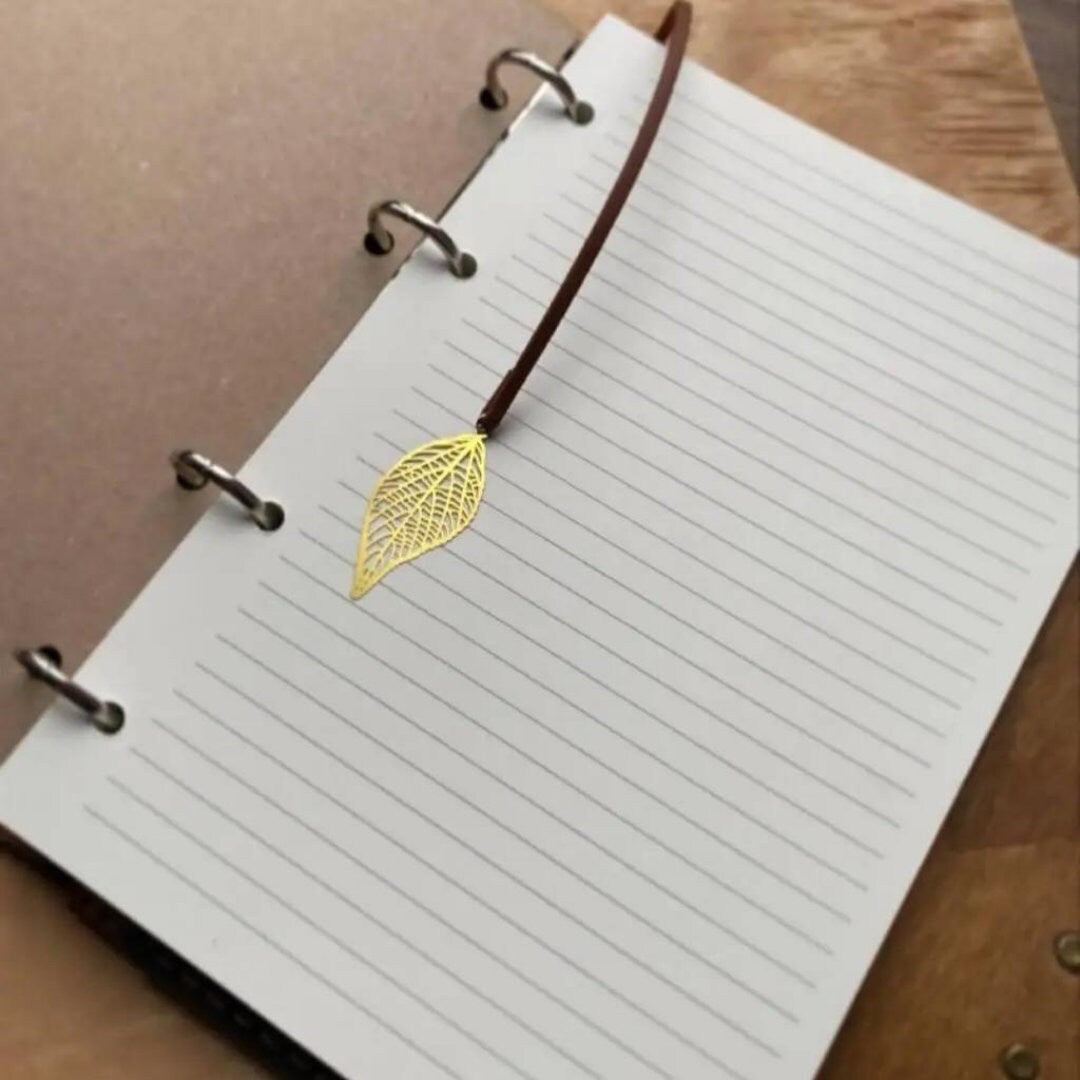 a notepad with a gold leaf on it