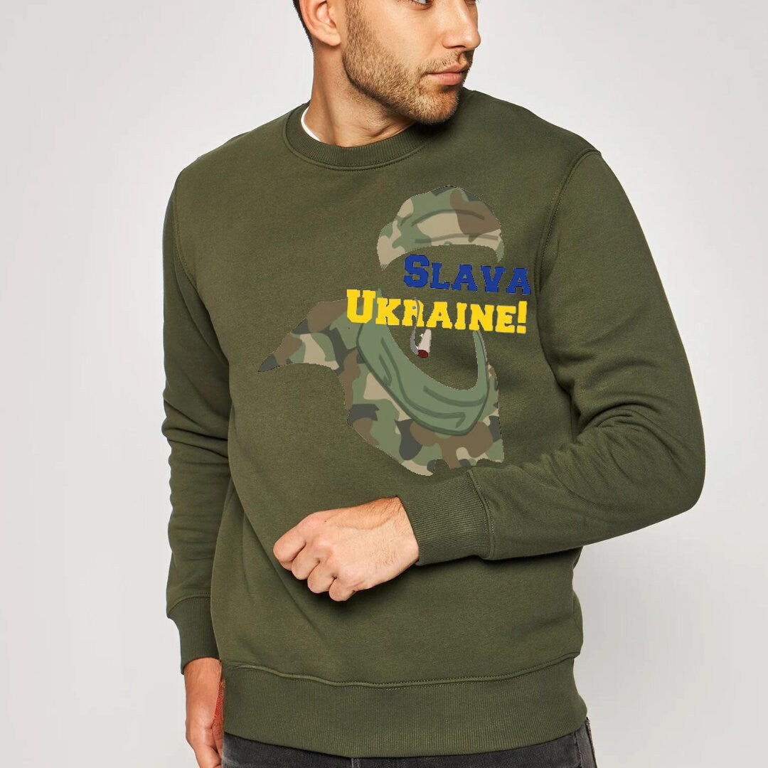 a man wearing a green sweatshirt with a camouflage print