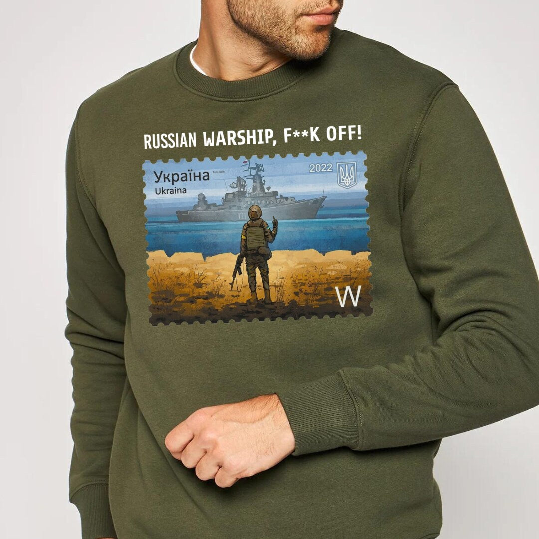 a man wearing a sweatshirt with a picture of a soldier on it