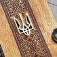 a close up of a wooden cutting board with a design on it