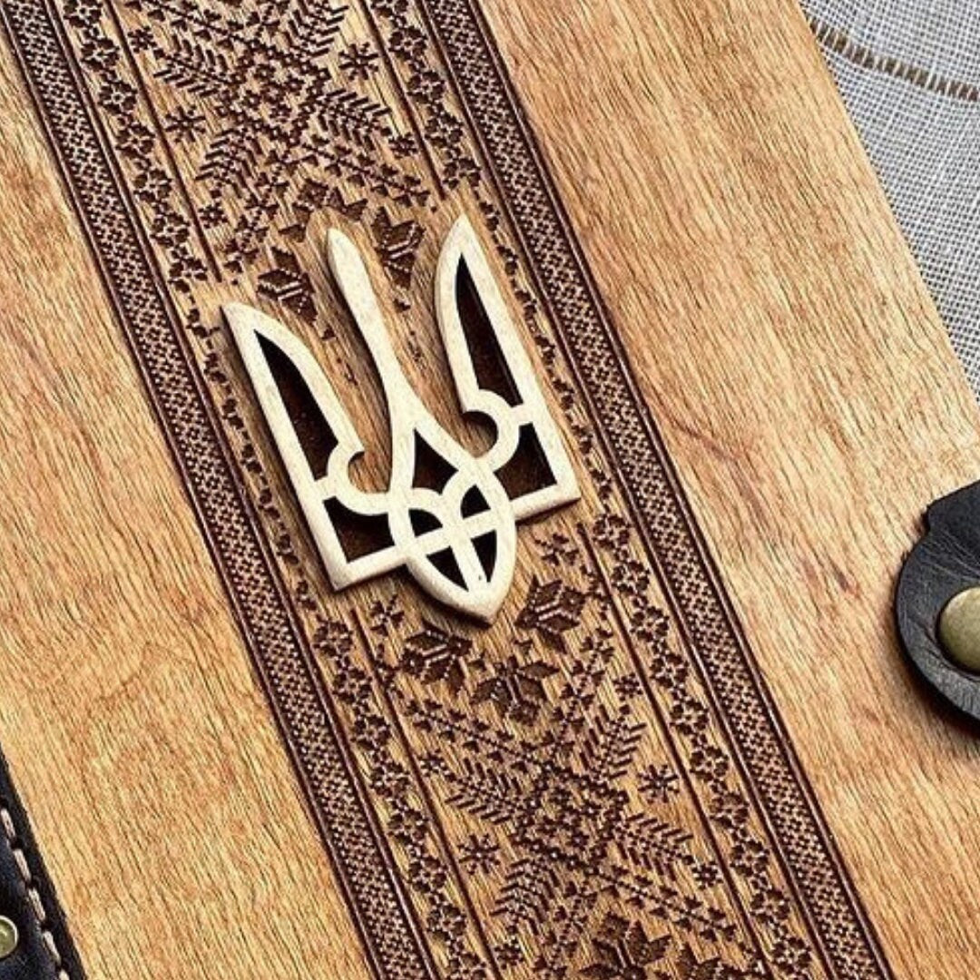 a close up of a wooden cutting board with a design on it