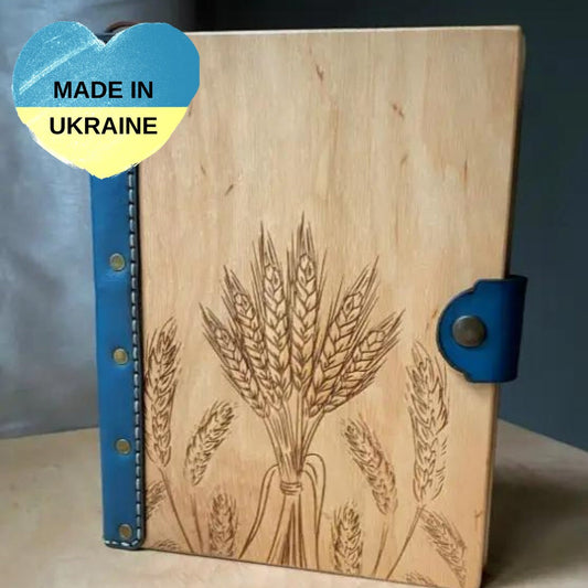 a wooden book with a picture of wheat on it