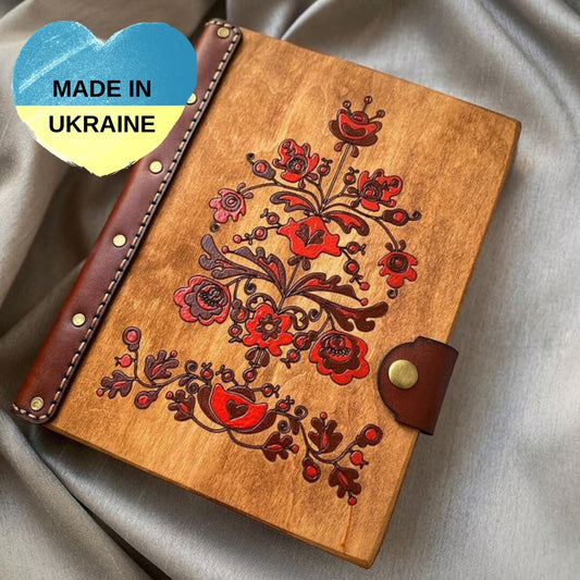 a wooden notebook with a floral design on it