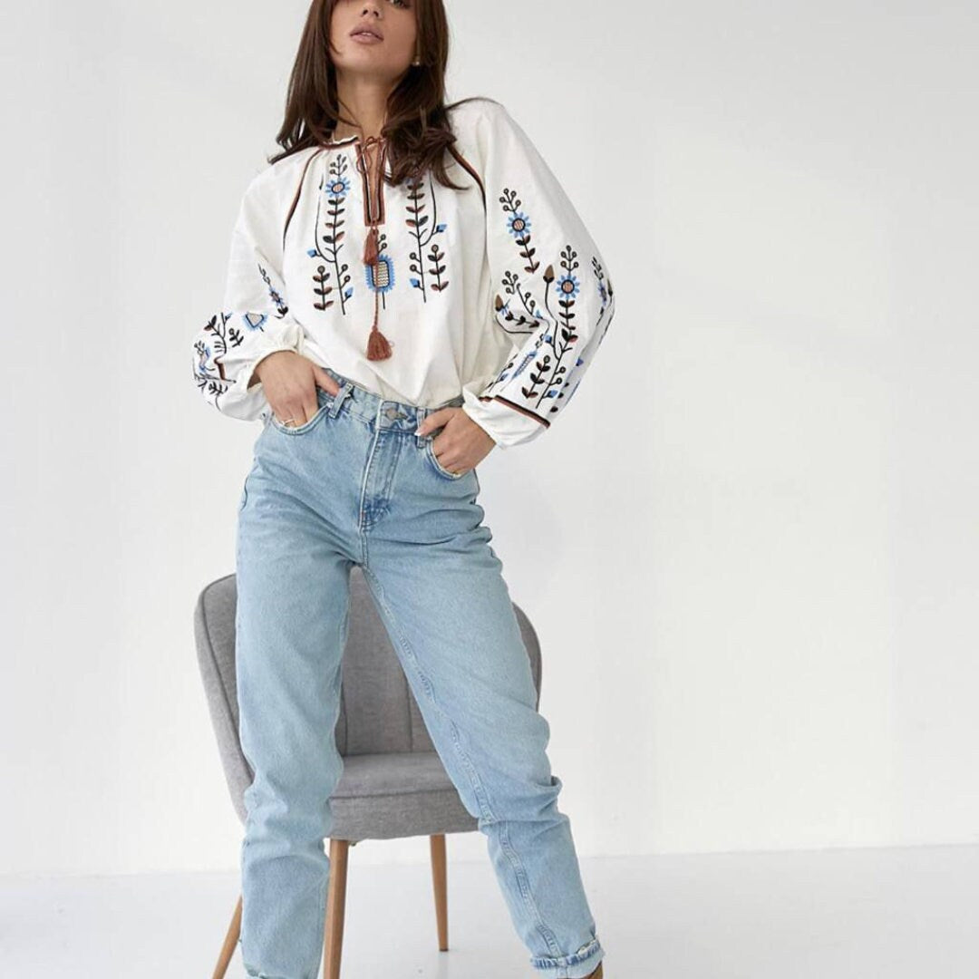 a woman sitting on a chair with her legs crossed