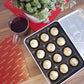 a tray of cookies next to a glass of wine