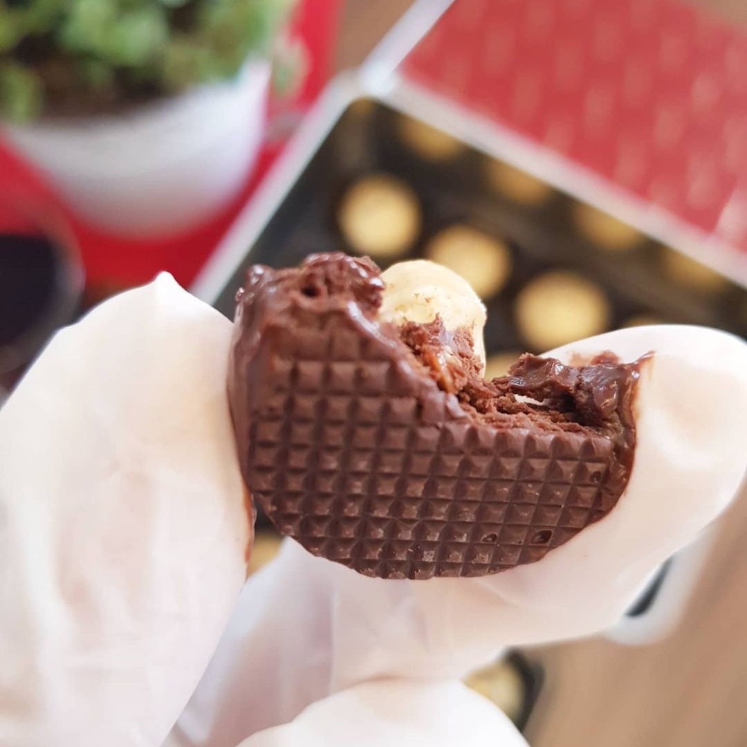 a close up of a person holding a piece of food