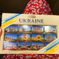 a person holding a box with pictures of ukraine