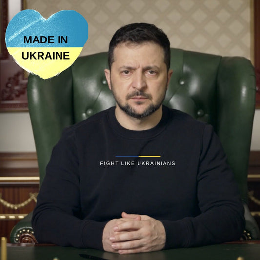 a man sitting in a green chair with his hands crossed