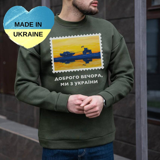 a man wearing a sweater with a picture of a plane on it