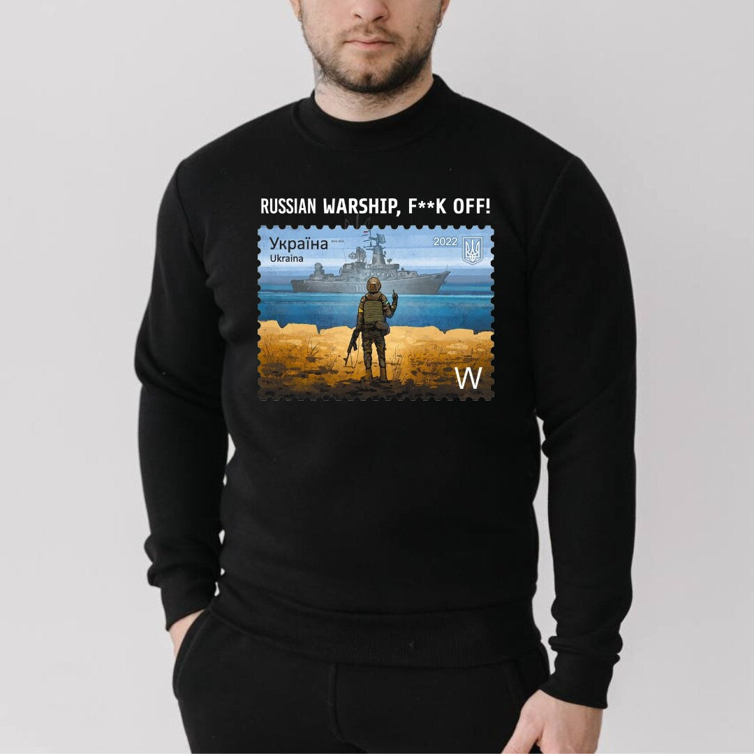 a man wearing a black sweatshirt with a picture of a soldier on it