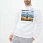 a man wearing a white sweatshirt with a picture of a man on it