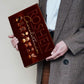 a man in a suit holding a box of chocolate