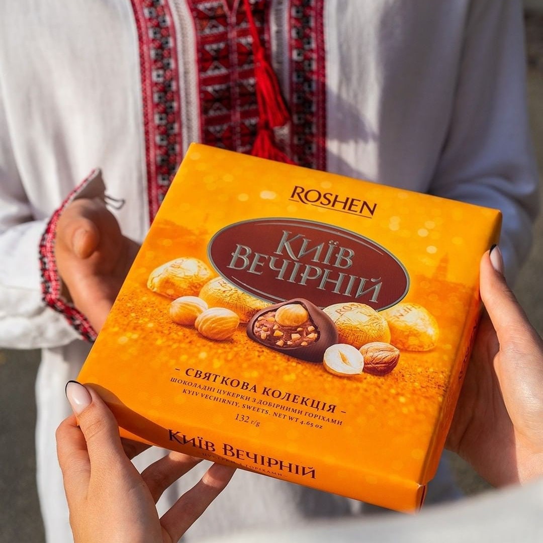 a person holding a box of nuts in their hands