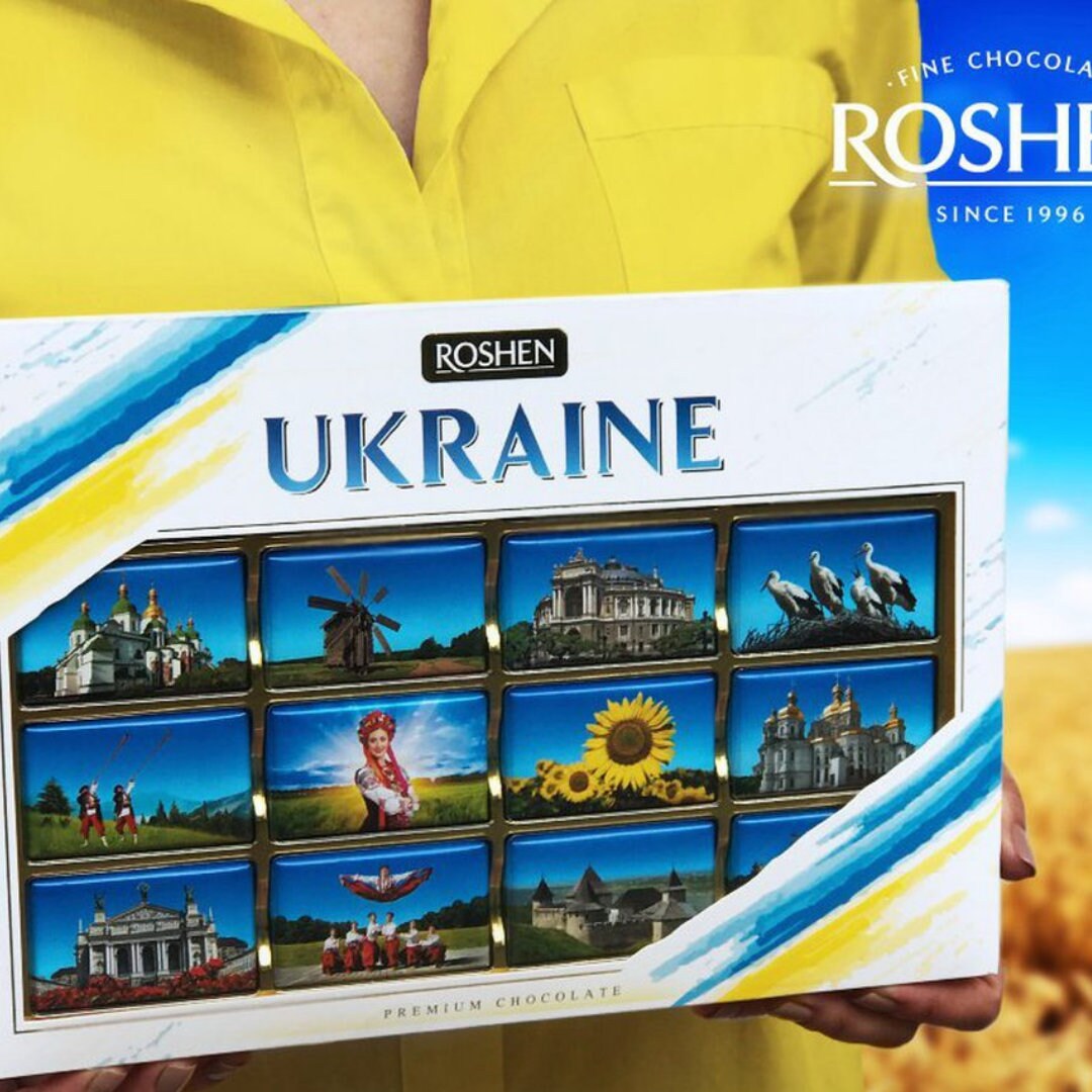 a person holding a box with pictures of ukraine