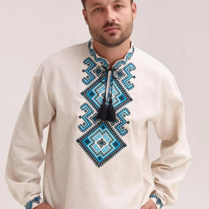 a man wearing a white shirt with a blue and black design on it