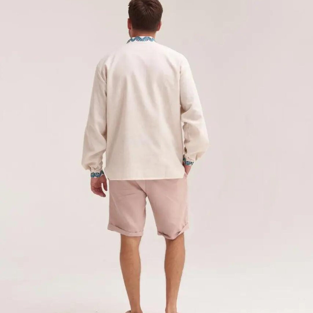 a man in a white shirt and pink shorts