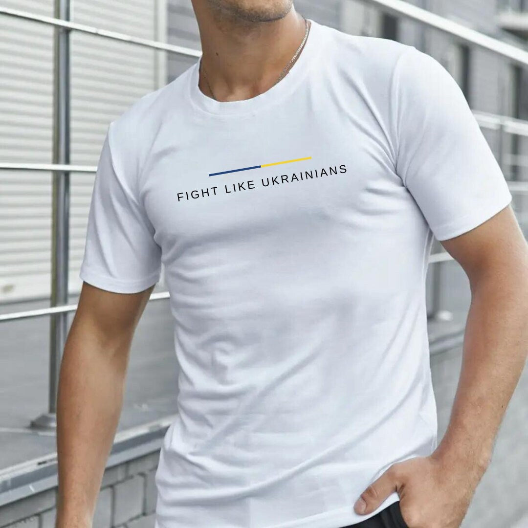 a man wearing a white t - shirt that says fight like ukraines