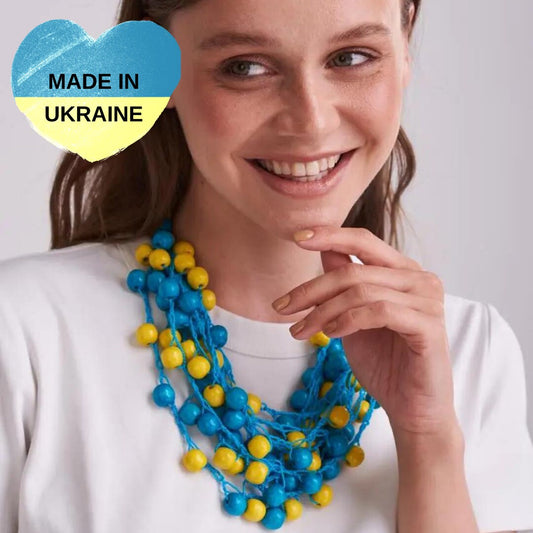 a woman wearing a blue and yellow beaded necklace