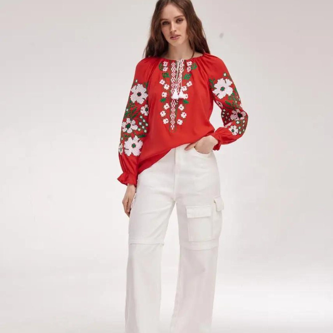 a woman in a red top and white pants