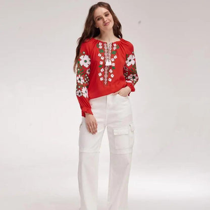 a woman wearing white pants and a red top