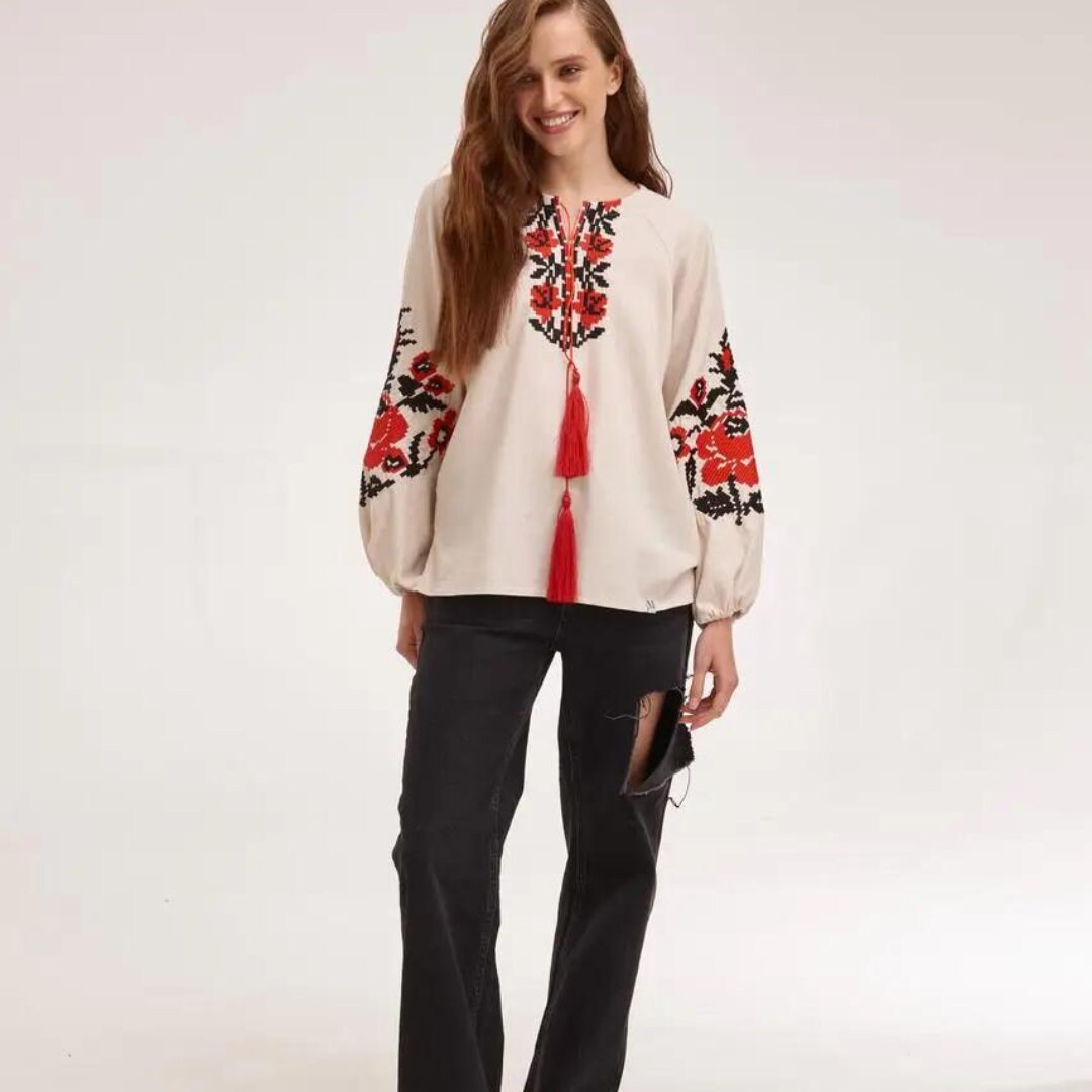 a woman standing in front of a white background