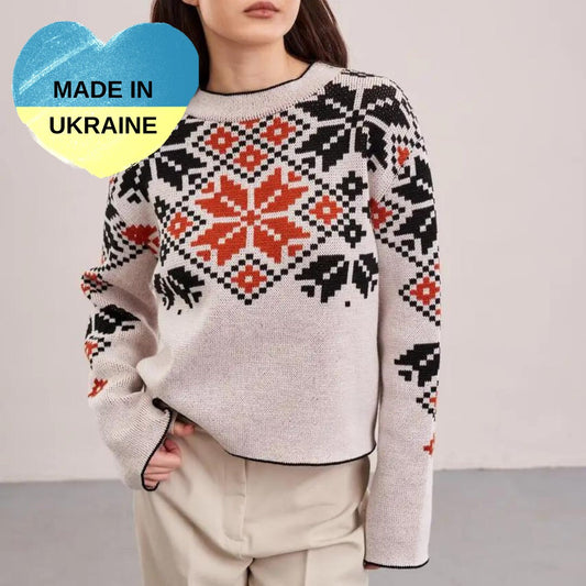 a woman wearing a sweater with a pattern on it