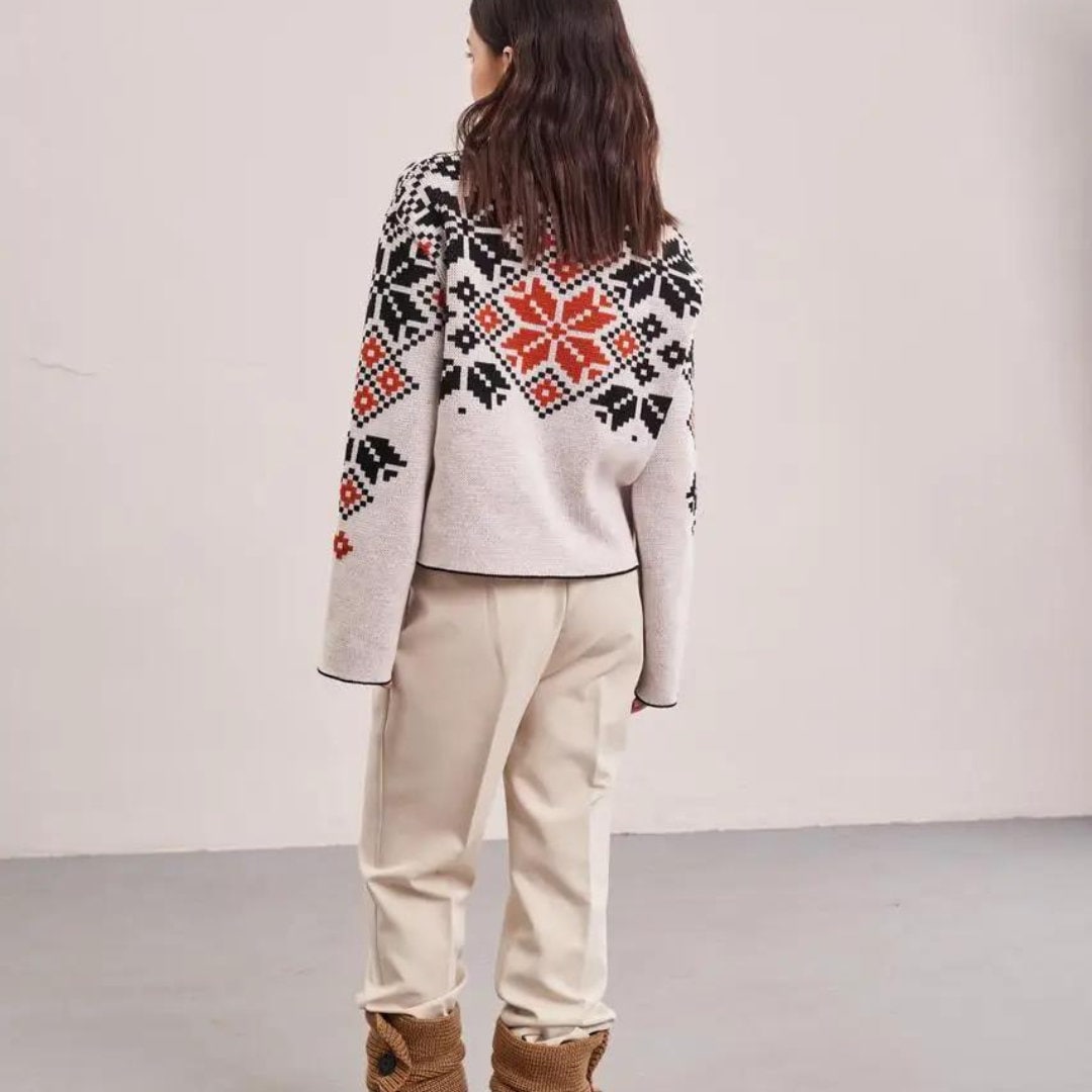 a woman standing in front of a white wall