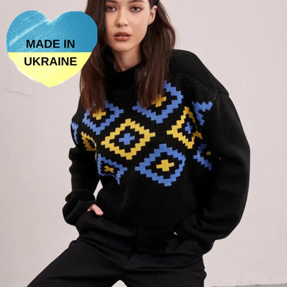 a woman in a black sweater and black pants