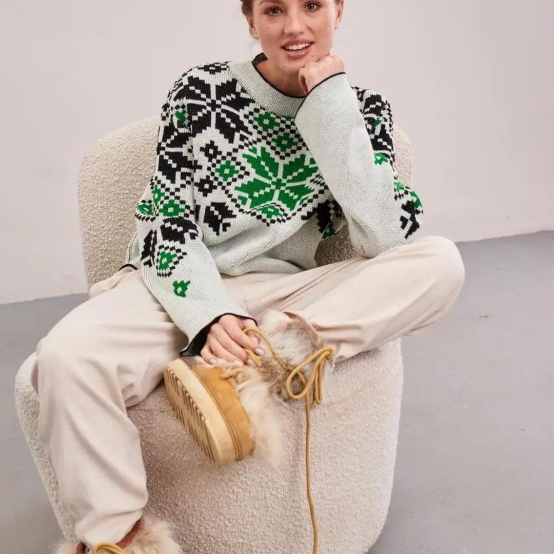 a woman sitting on top of a white chair