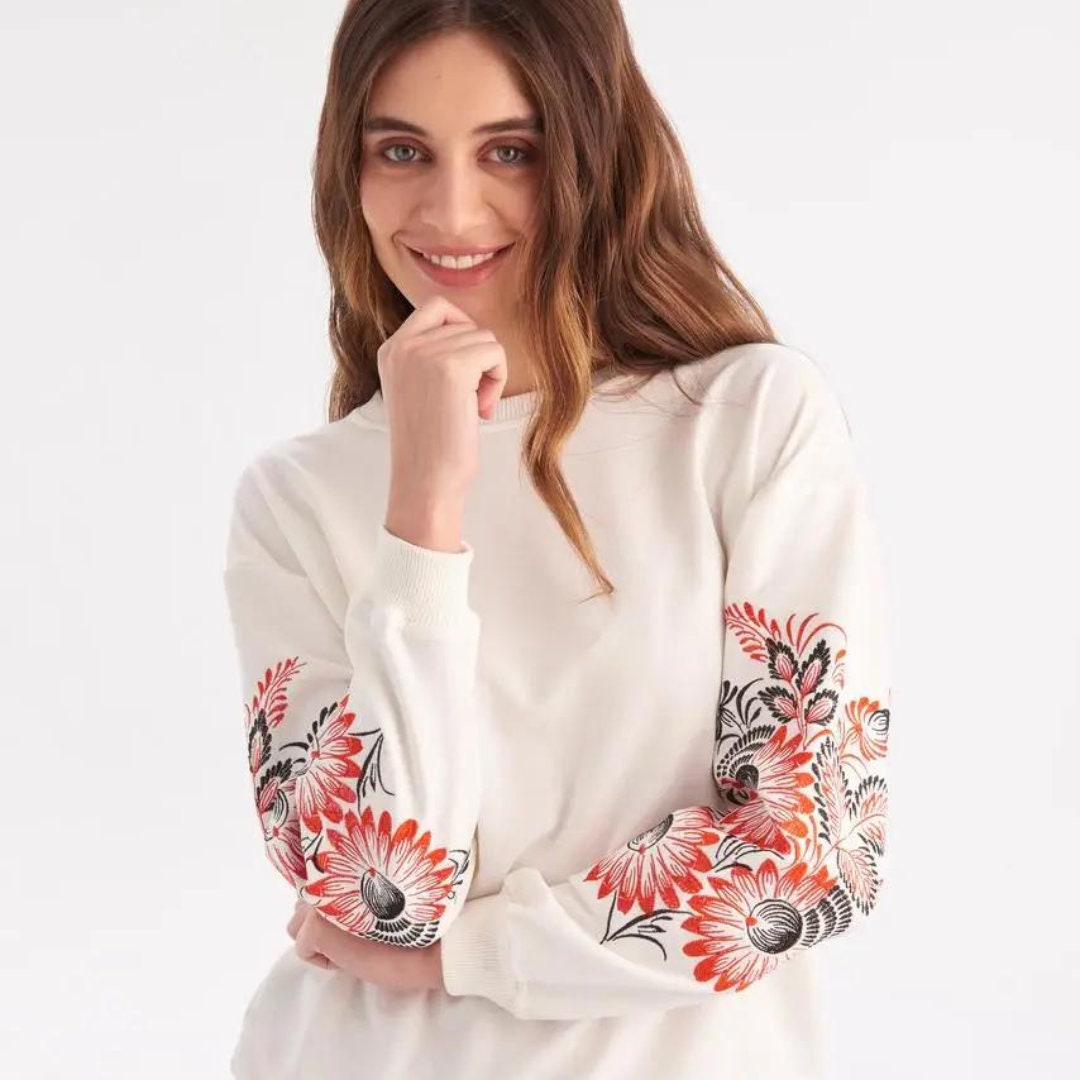 a woman posing for a picture with her hand on her chin